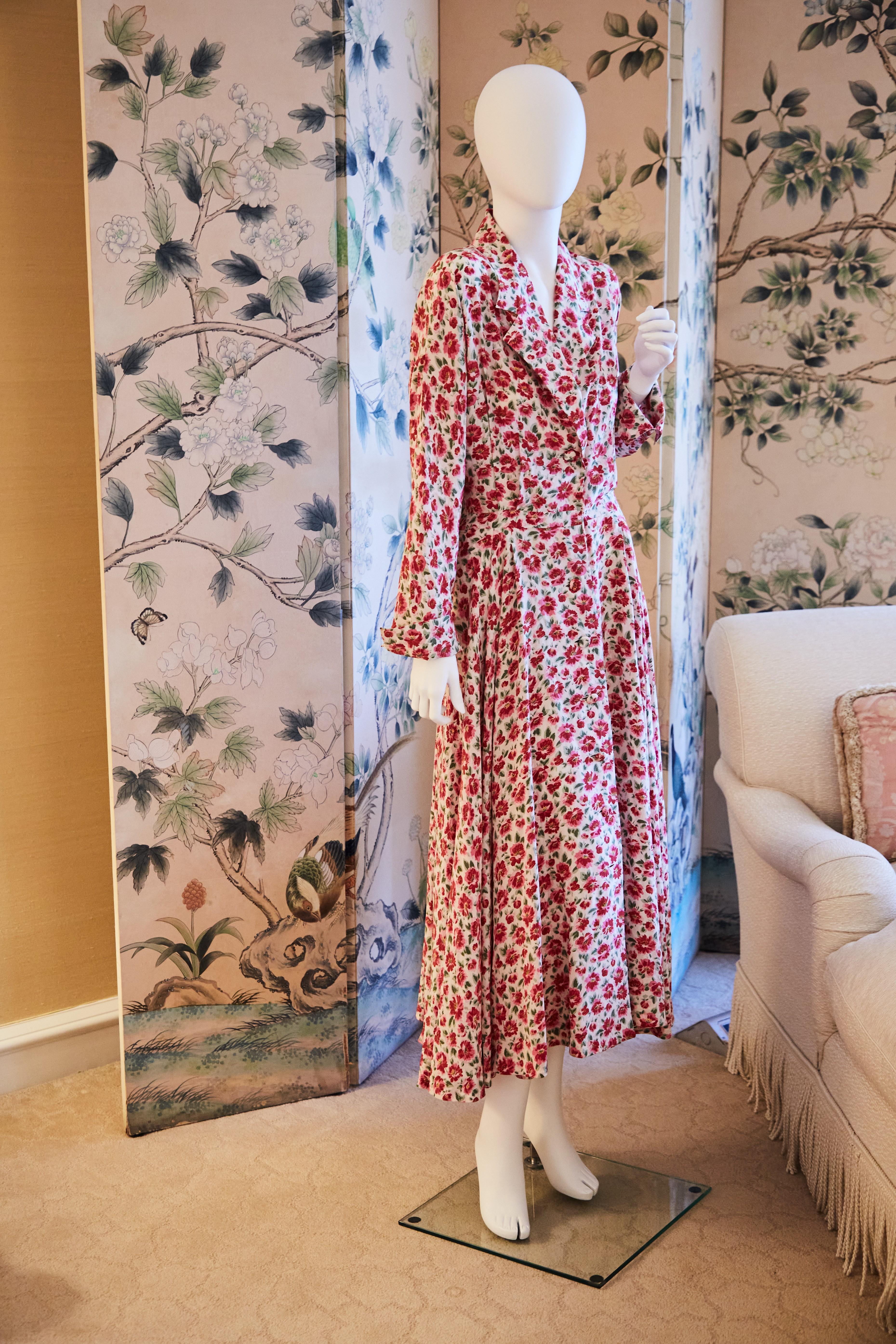 a mannequin is wearing a red and white floral dress