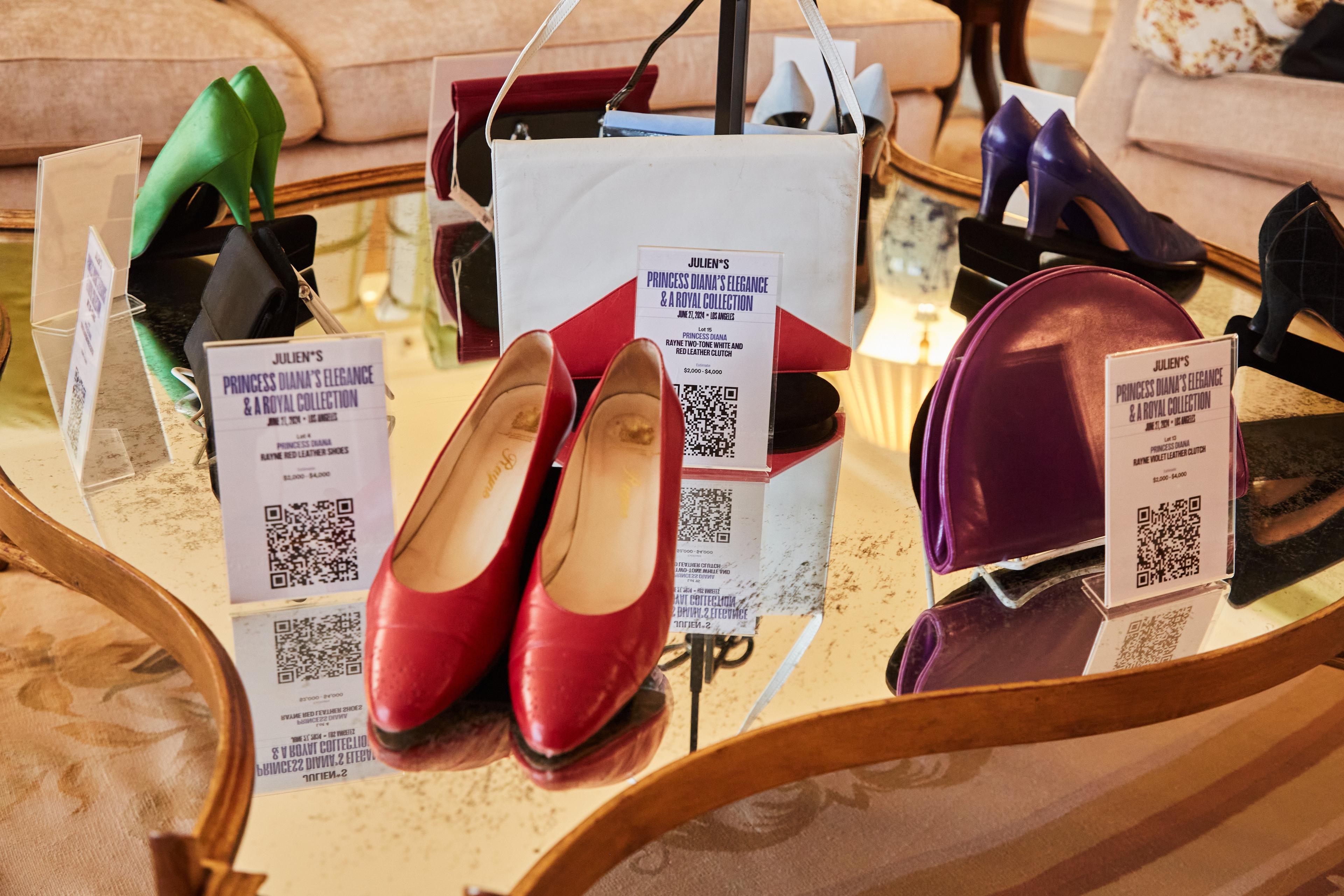 a table with a pair of red shoes and a purple bag on it .